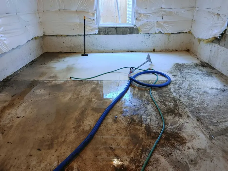 Restoration technician drying a water damaged Peyton, CO home with air movers