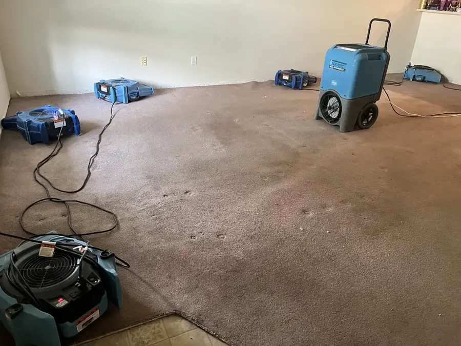 Water spreading across the floor from a burst pipe in a Peyton, CO home